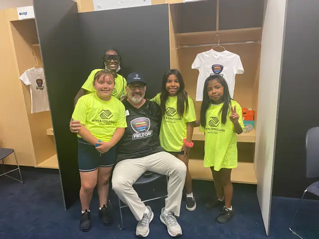 Children in neon Global Field Day shirts inside the stadium locker room